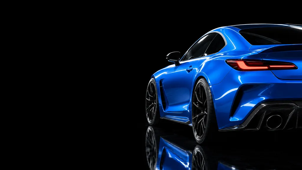 Blaues Sportcoupé von schräg hinten vor schwarzem Hintergrund, mit roten Rückleuchten und schwarzen Felgen. Der glänzende Boden spiegelt das Auto.